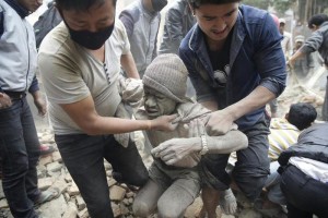 People free a man from the rubble of a destroyed building after an earthquake hit Nepal, in Kathmandu, Nepal, 25 April 2015. A 7.9-magnitude earthquake rocked Nepal destroying buildings in Kathmandu and surrounding areas, with unconfirmed rumours of casualties. The epicentre was 80 kilometres north-west of Kathmandu, United States Geological Survey. Strong tremors were also felt in large areas of northern and eastern India and Bangladesh. EPA / NARENDRA SHRESTHA